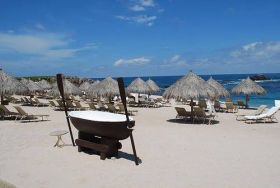 White sand beach with thatched umbrellas in Puerto Vallarta, Mexico – Best Places In The World To Retire – International Living